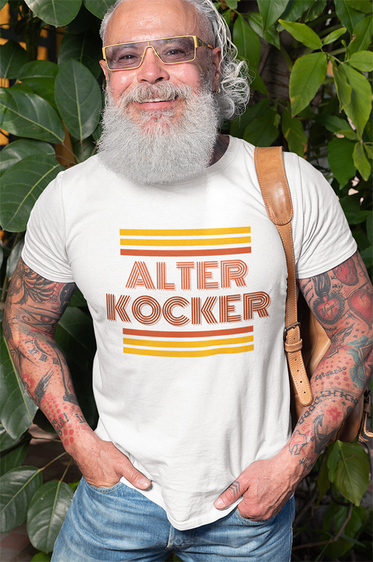 Man wearing a white t-shirt with 'ALTER KOCKER' text and graphics, standing outdoors.