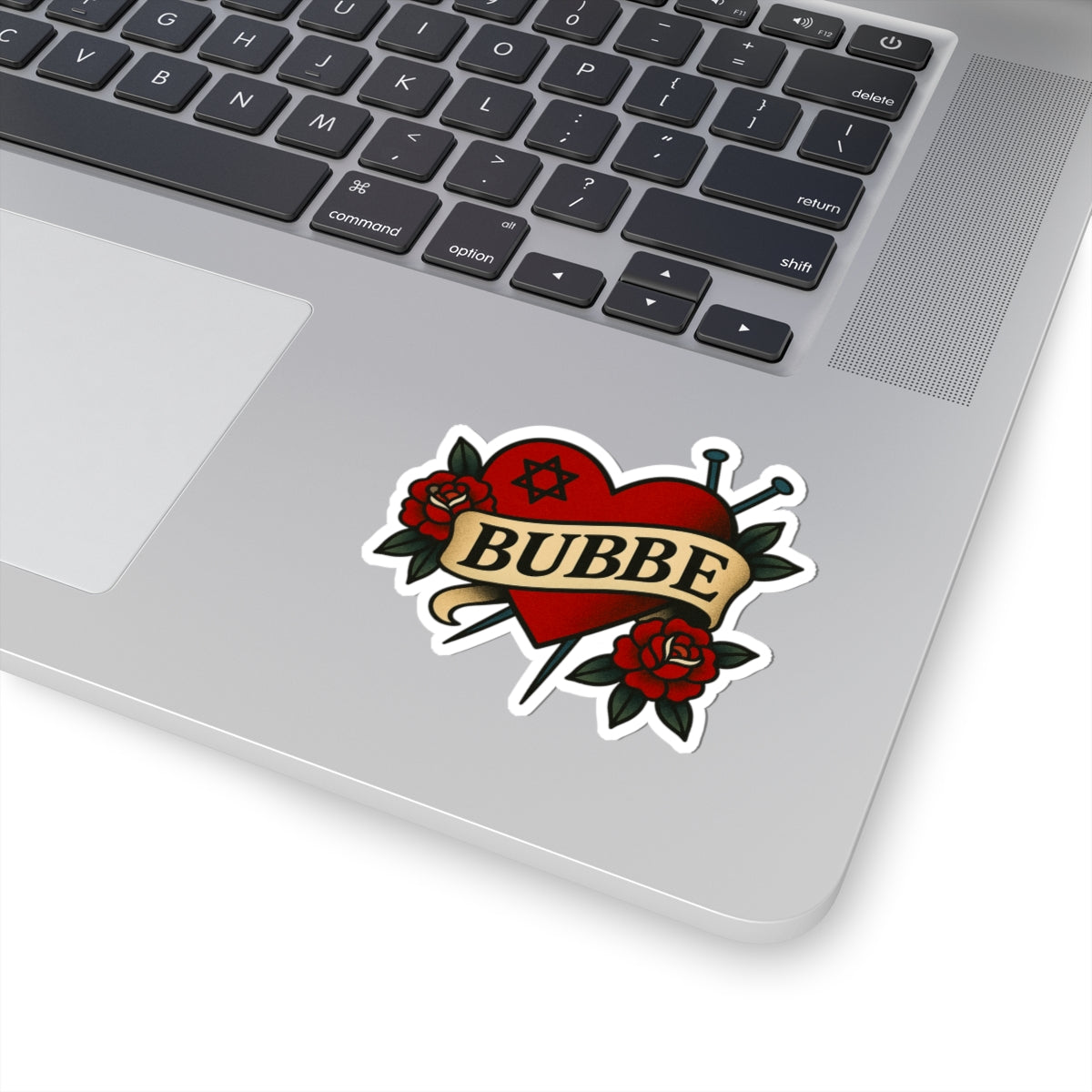 Laptop with a 'BUBBE' tattoo-style sticker on the palm rest area