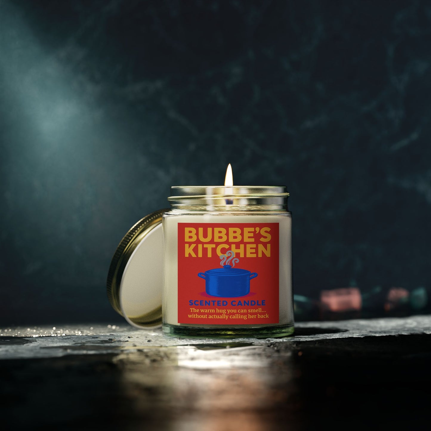 Bubbe's Kitchen scented candle with a red label on a dark background