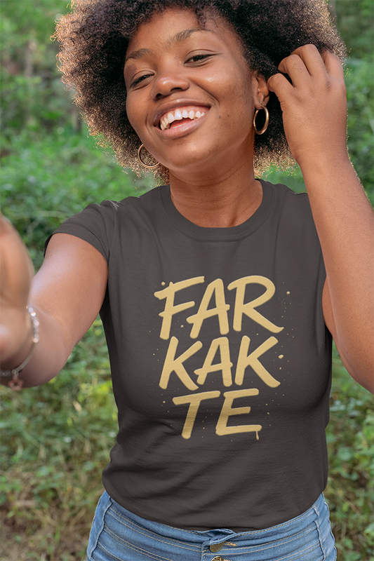 Person wearing a black t-shirt with 'FARKAKTE' in yellow text, outdoors.