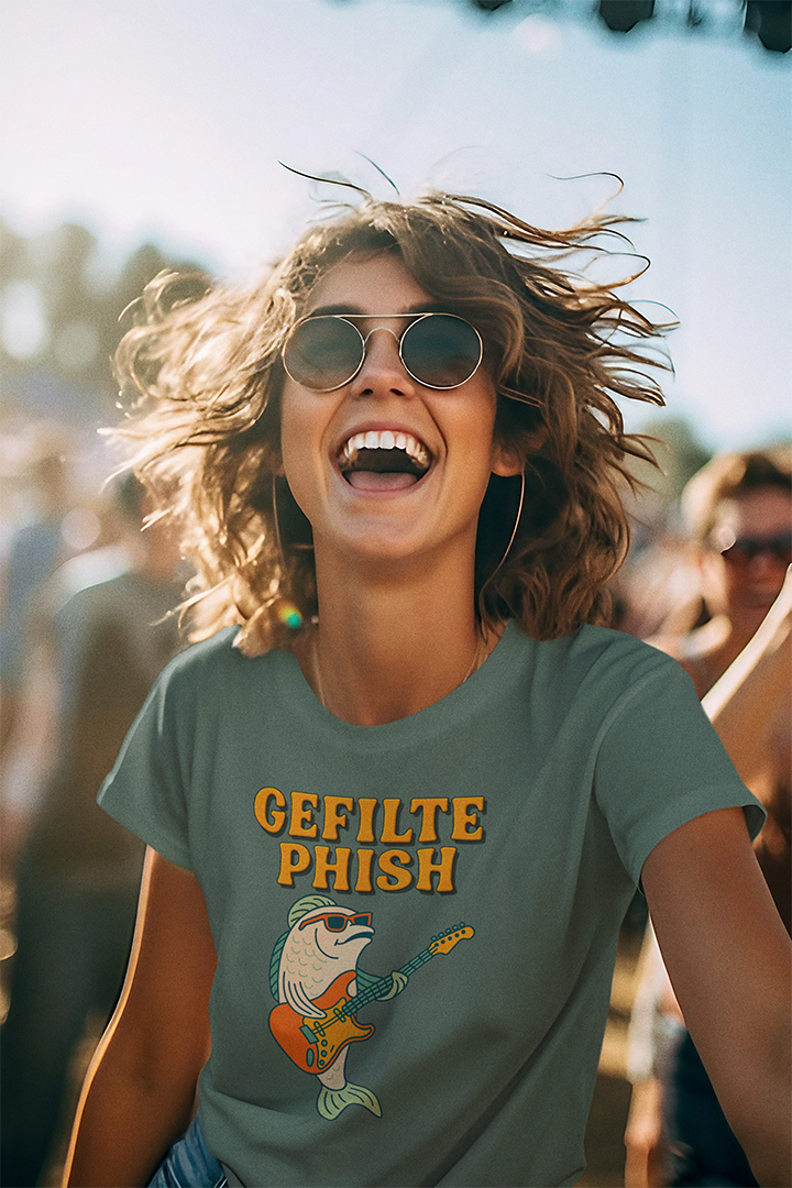 Person wearing a 'Gefilte Phish' t-shirt at a music festival