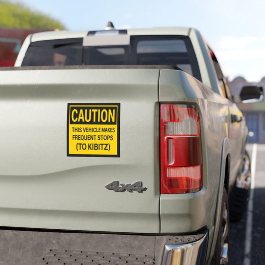 Back of a truck with a humorous 'Caution' Magnet