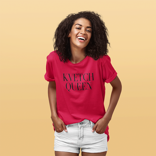 Woman wearing a pink t-shirt with 'KVETCH QUEEN' text on a beige background