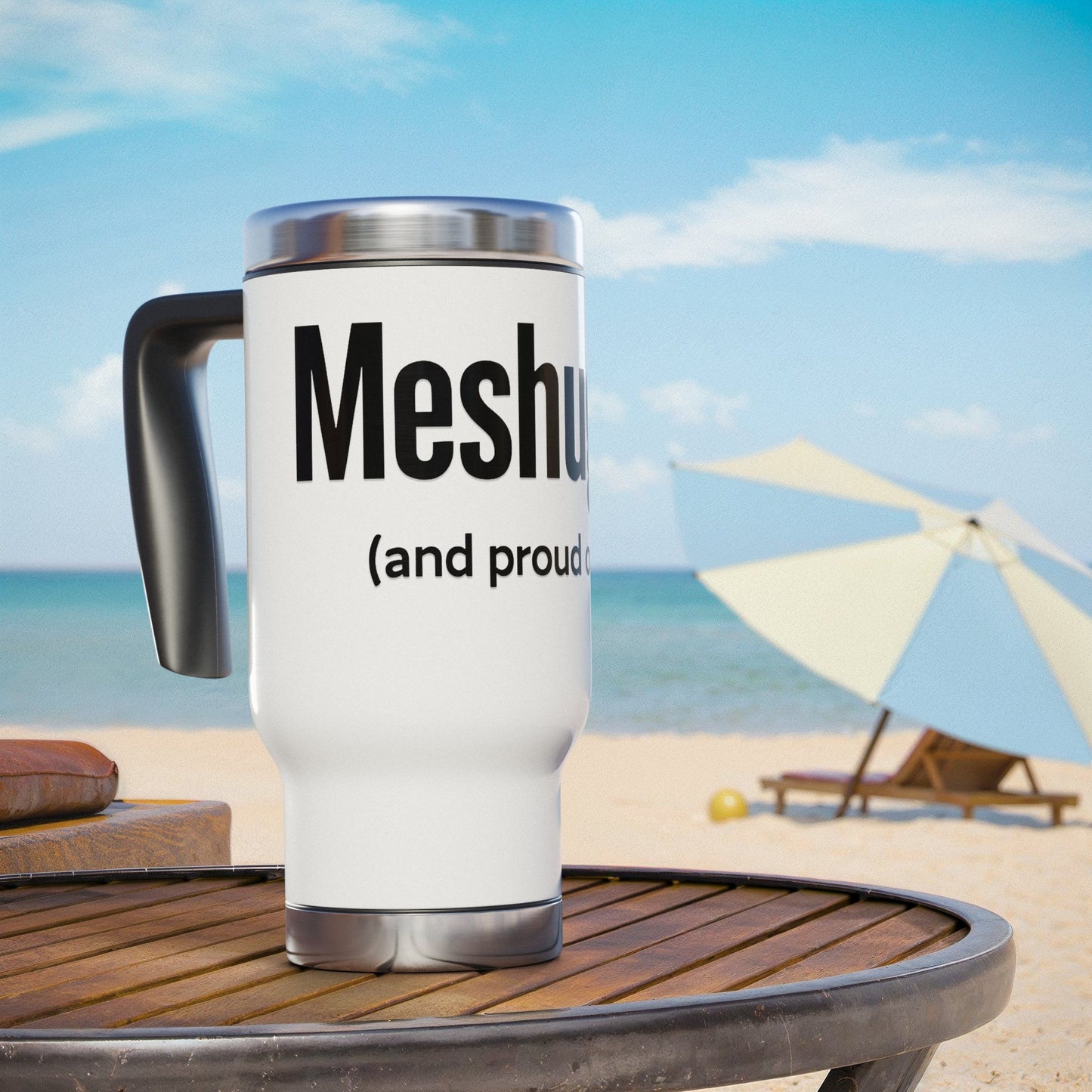 White travel mug with 'Meshugga' (and proud)' text on a beach setting