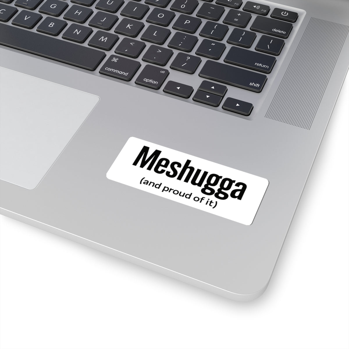Laptop with a 'Meshugga (and proud of it)' sticker on the palm rest area.
