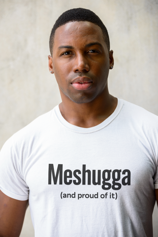 Man wearing a white t-shirt with 'Meshugga (and proud of it)' text against a neutral background