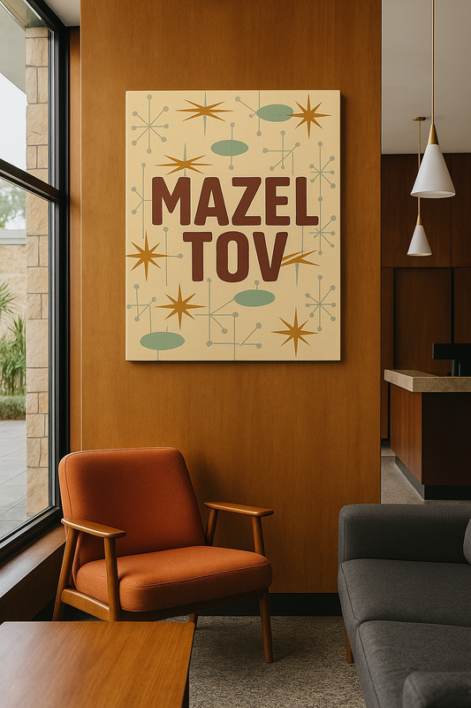 Mazel Tov print on a wall with an orange chair and gray sofa in a room.