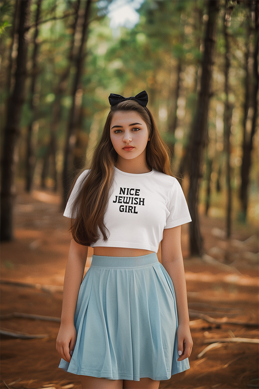 Woman wearing a white t-shirt with 'Nice Jewish Girl' text in a forest setting