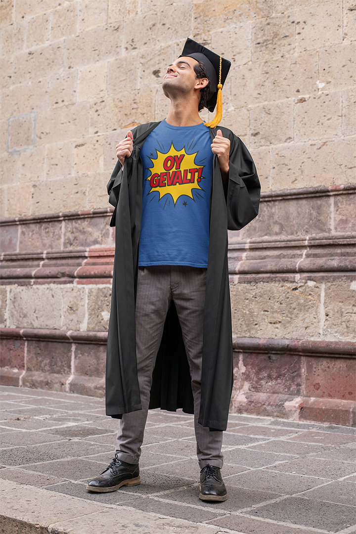 Graduate wearing a blue t-shirt with a yellow graphic design, standing against a stone wall.