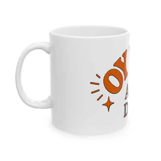 White mug with orange text and design on a white background