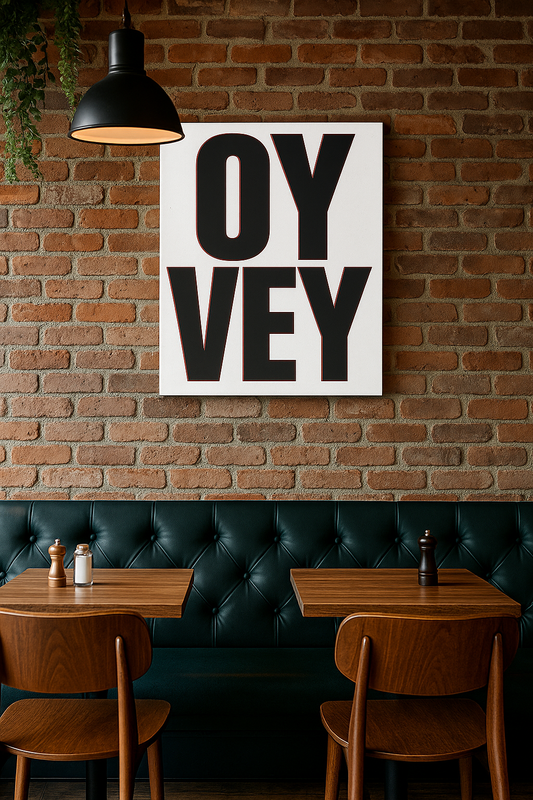 Restaurant interior with 'OY Vey' print on brick wall, wooden tables, and chairs.