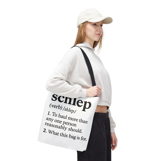 Person holding a tote bag with text design on a white background