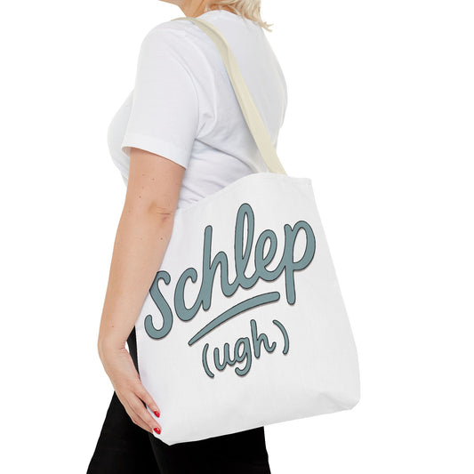 Person holding a white tote bag with 'Schlep (ugh)' text.