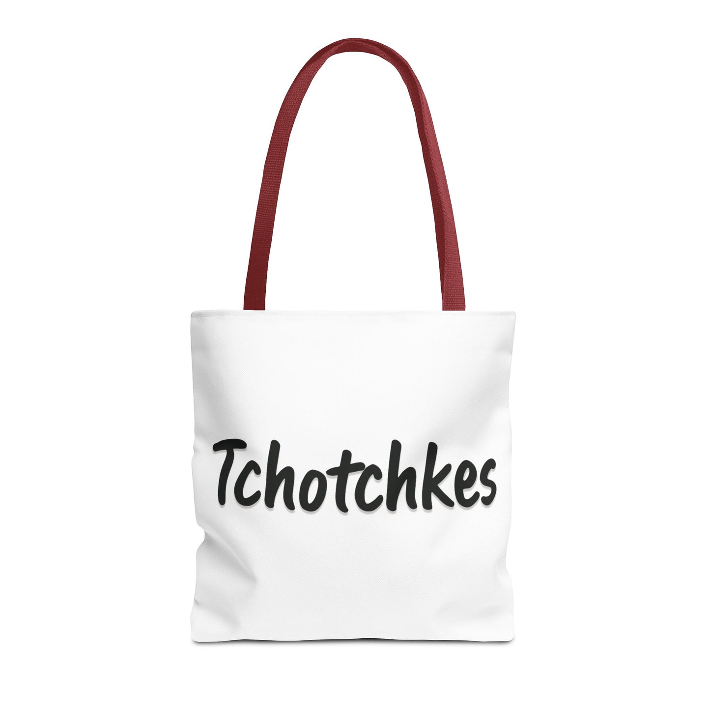 White tote bag with red handles and 'Tchotchkes' text on a white background