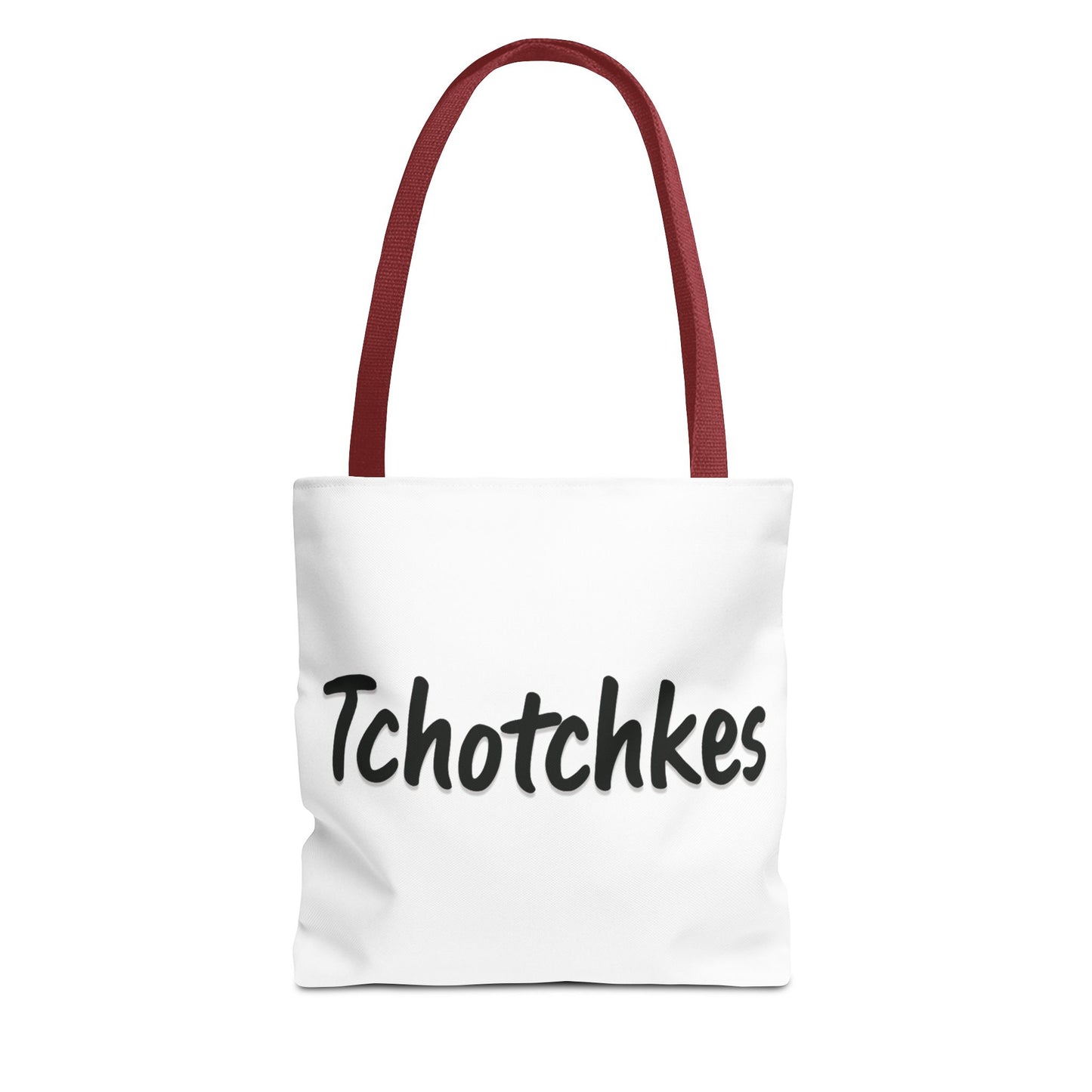 White tote bag with red handles and 'Tchotchkes' text on a white background