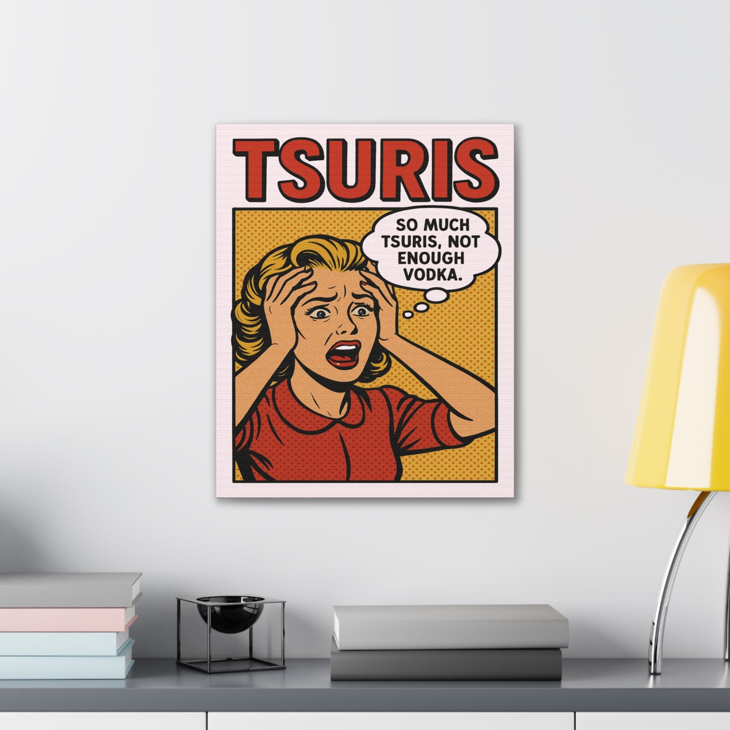 Framed artwork with a comic-style design of a woman with a speech bubble, on a white wall above a shelf.