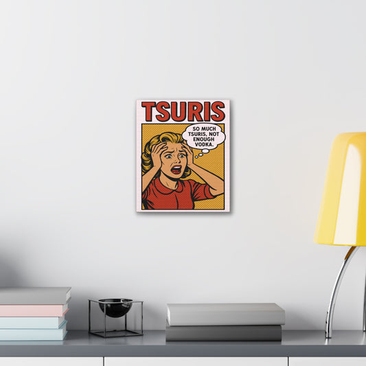 Framed poster with 'TSURIS' design on a wall above a desk with books and a lamp.