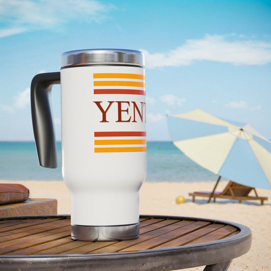 White travel mug with colorful design on a beach setting