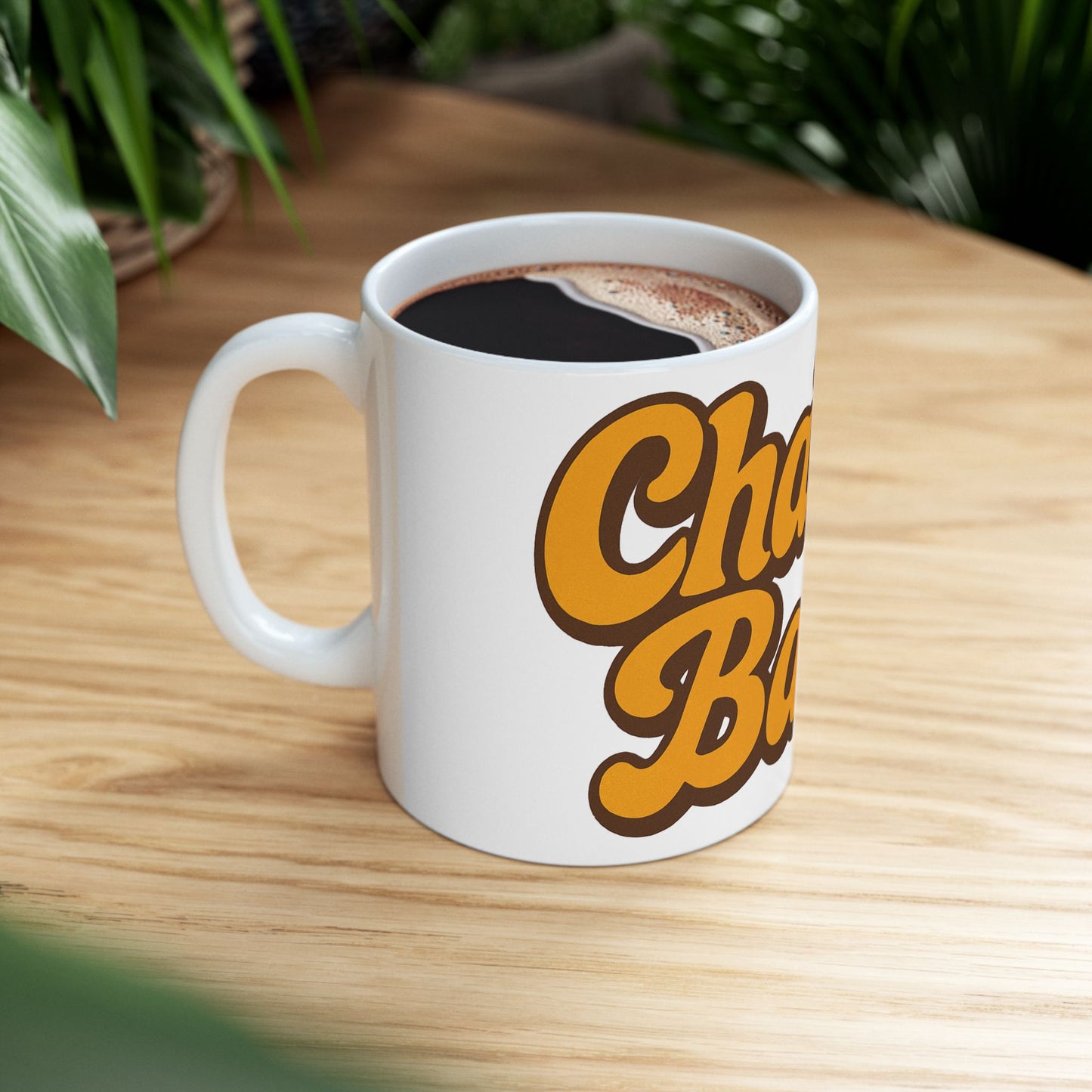 White mug with 'Challah Back' text on a wooden table