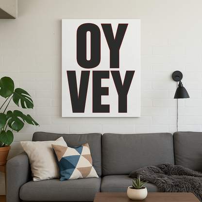 Living room with a gray sofa, decorative pillows, and a 'OY Vey' artwork on the wall.
