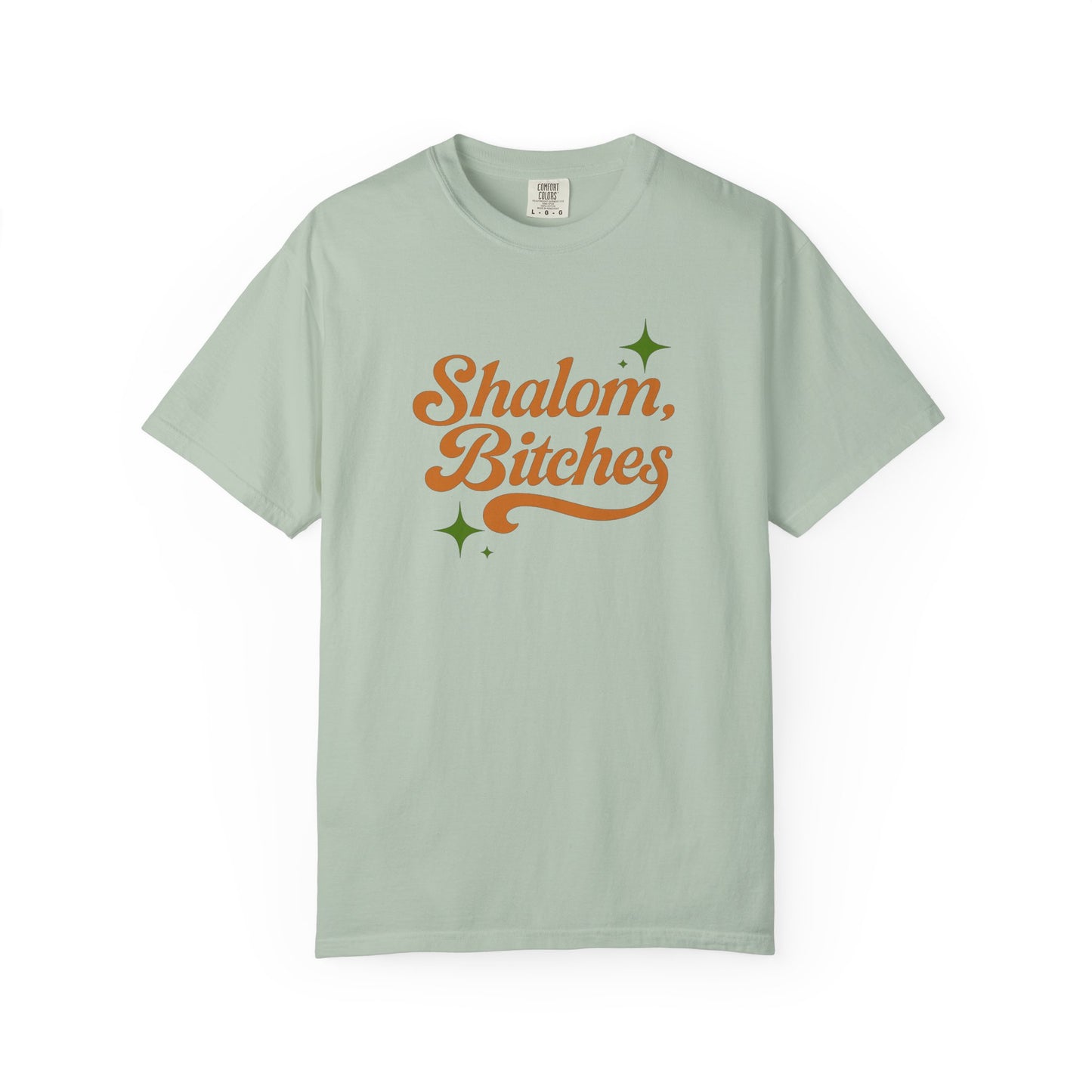 Light green t-shirt with 'Shalom, Bitches' text on a white background