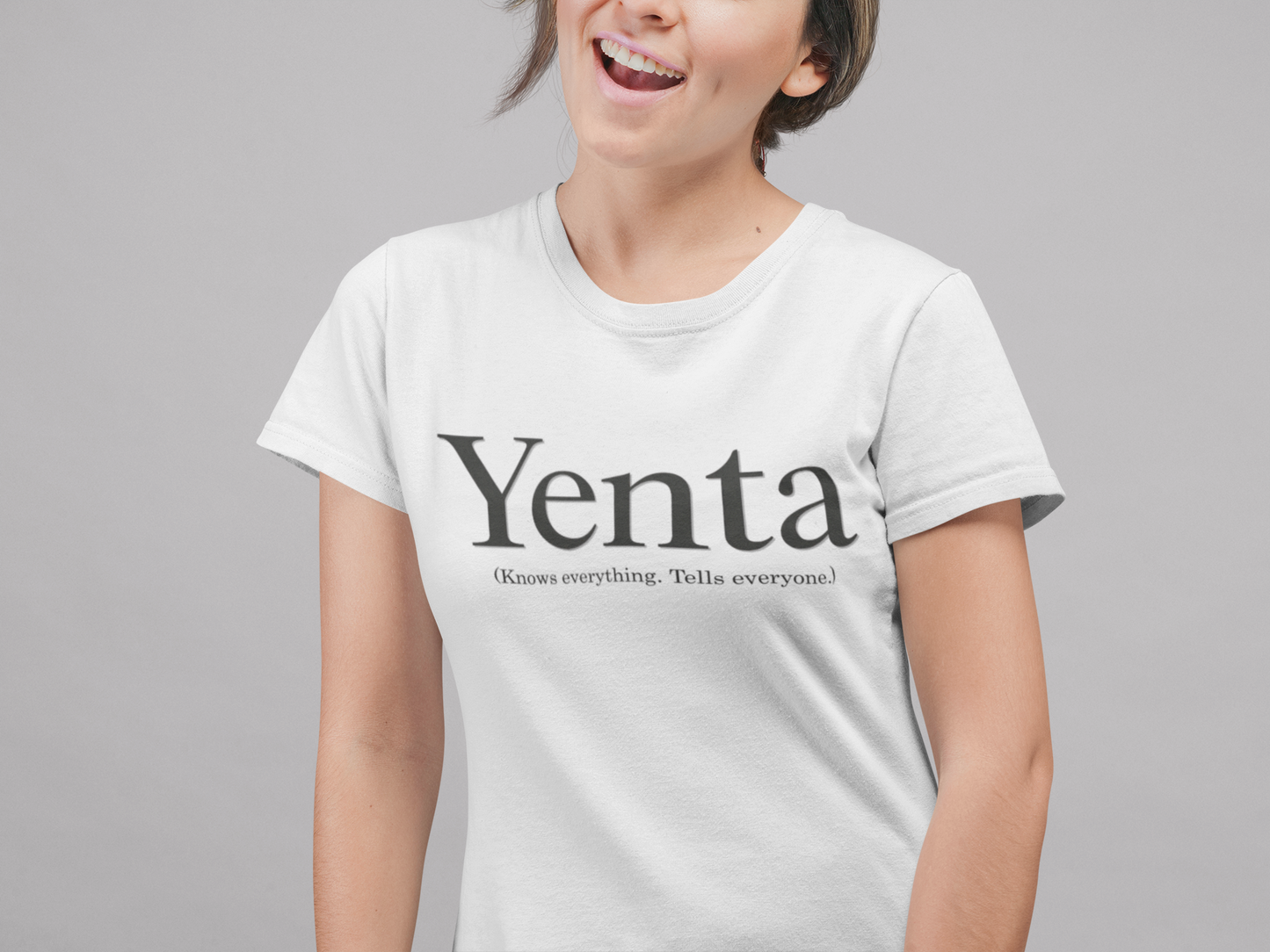 Person wearing a white t-shirt with 'Yenta does everything. Tells everyone!' text on a gray background