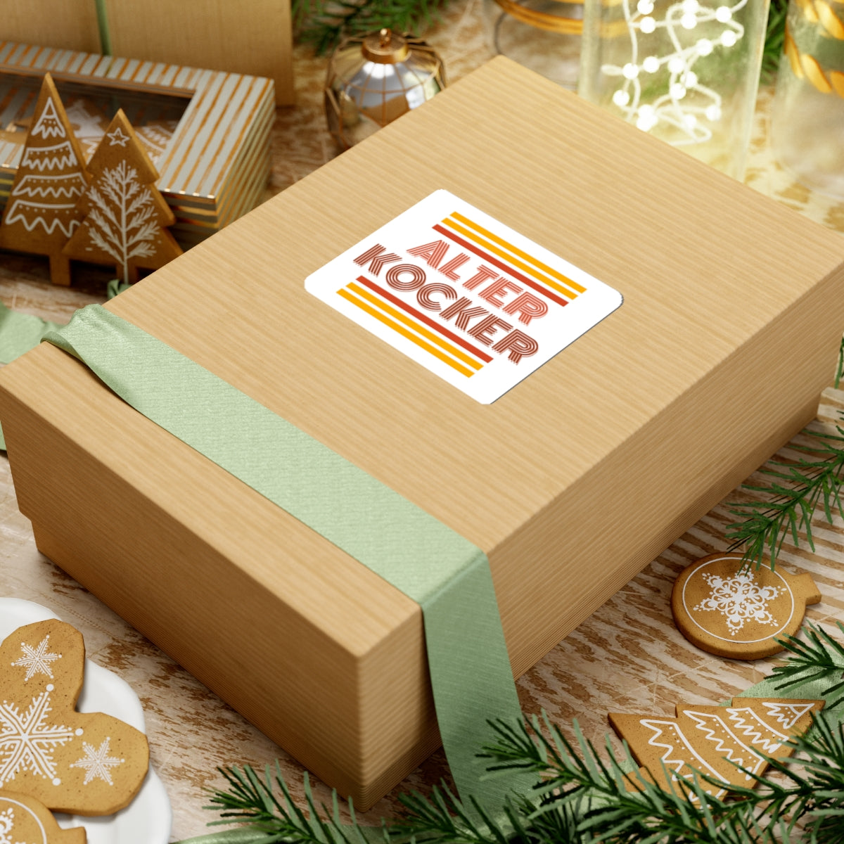Wooden gift box with a 'Alter Kocker' label on a festive background with cookies and greenery.
