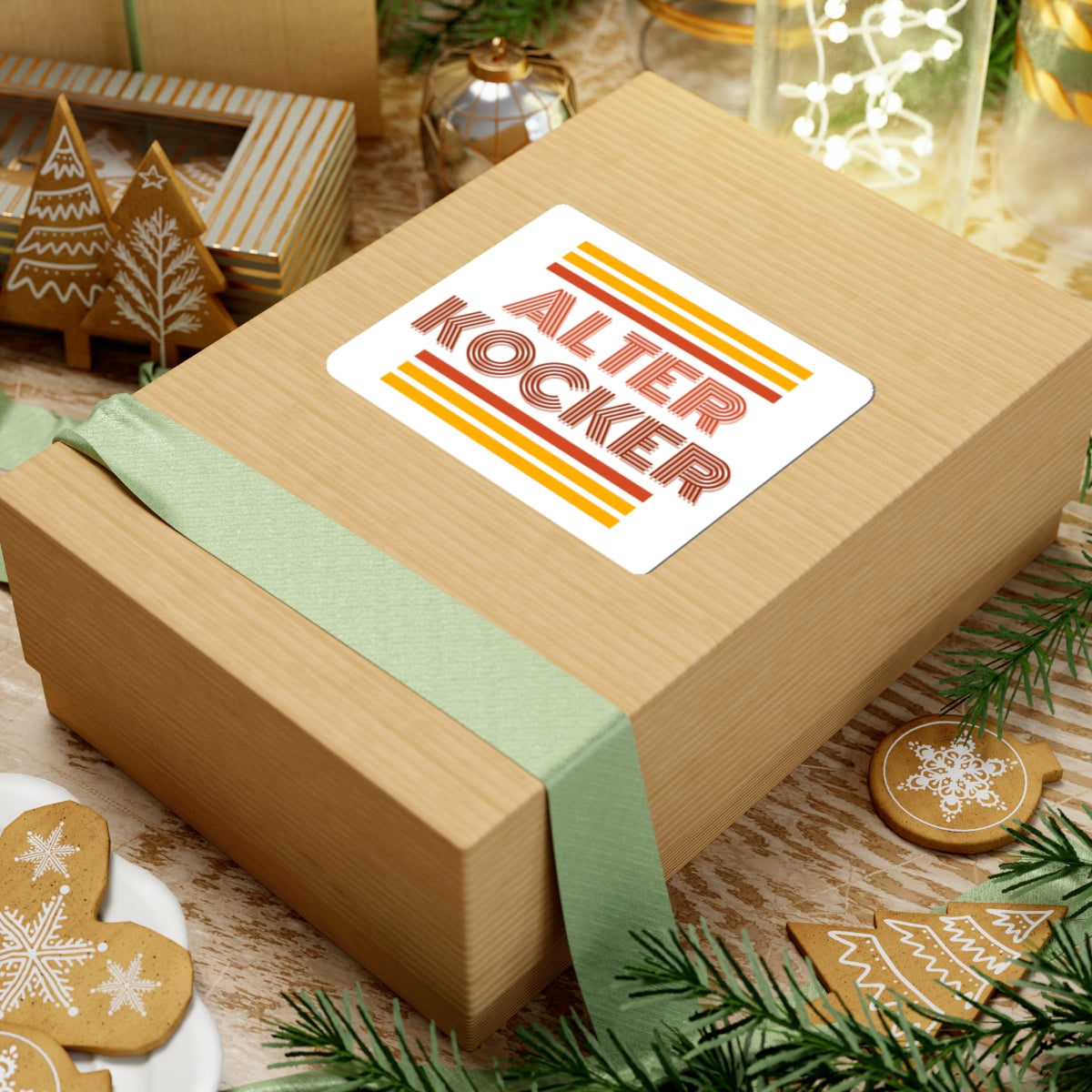 Wooden gift box with a 'Alter Kocker' label, surrounded by Christmas decorations.