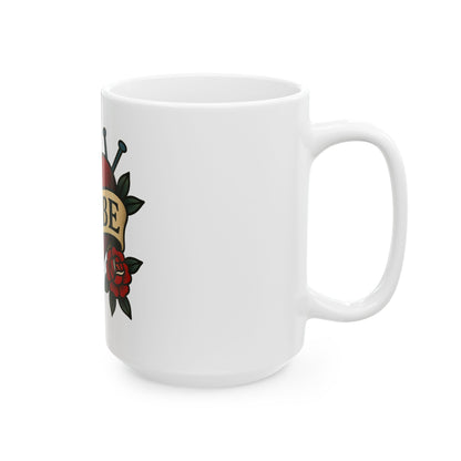 White mug with tattoo-style design featuring a rose and snake on a white background