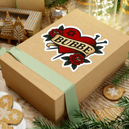 Wooden gift box with a 'Bubbe' sticker on a festive background with cookies and lights.