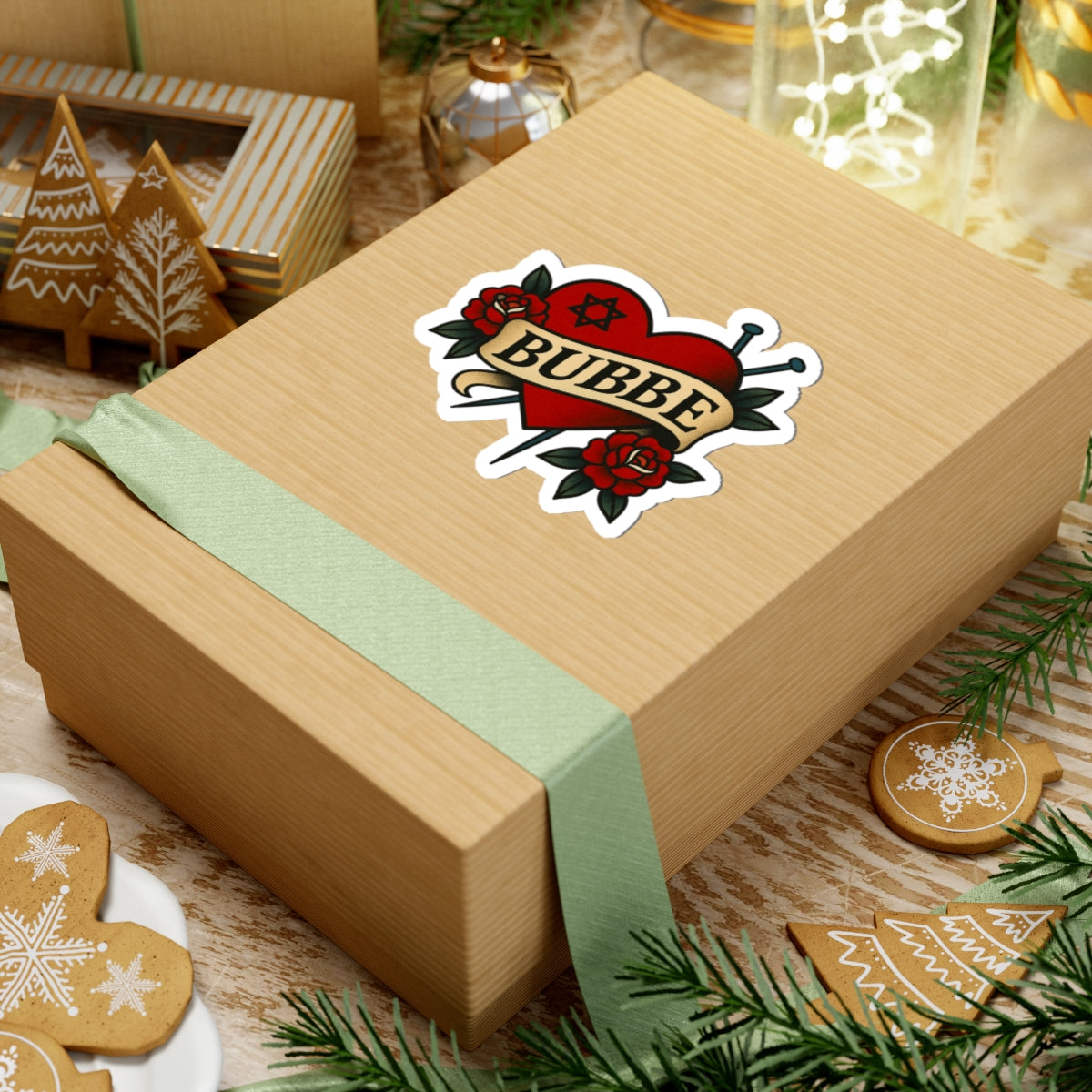 Wooden gift box with a 'Bubbe' sticker on a festive background with cookies and lights.