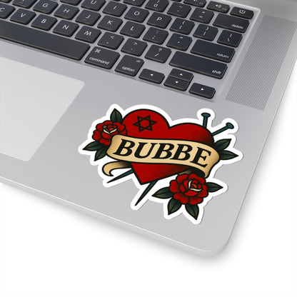 Laptop with a 'BUBBE' tattoo-style sticker featuring roses and a star of David.