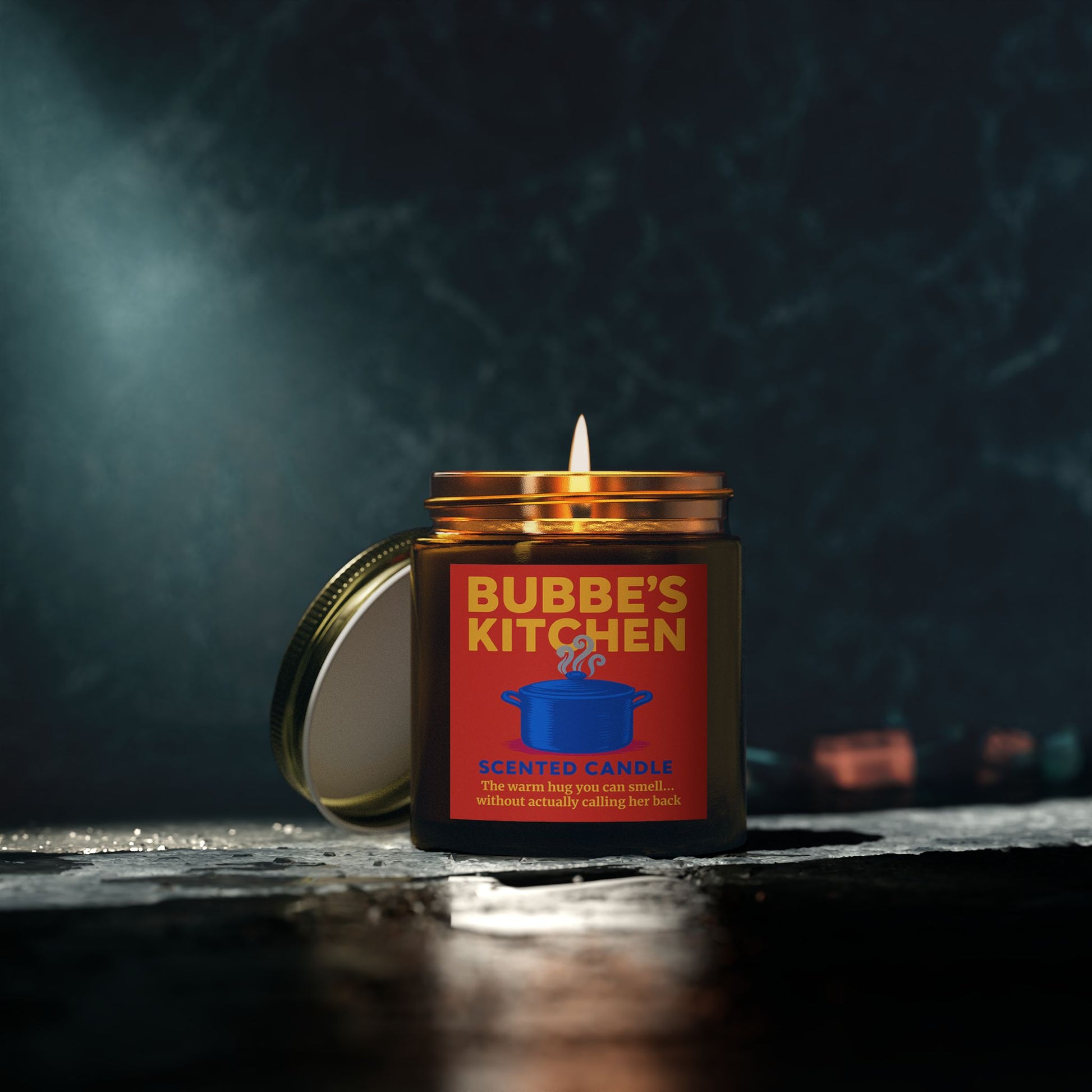 Candle in a jar labeled 'Bubbe's Kitchen' with a dark background