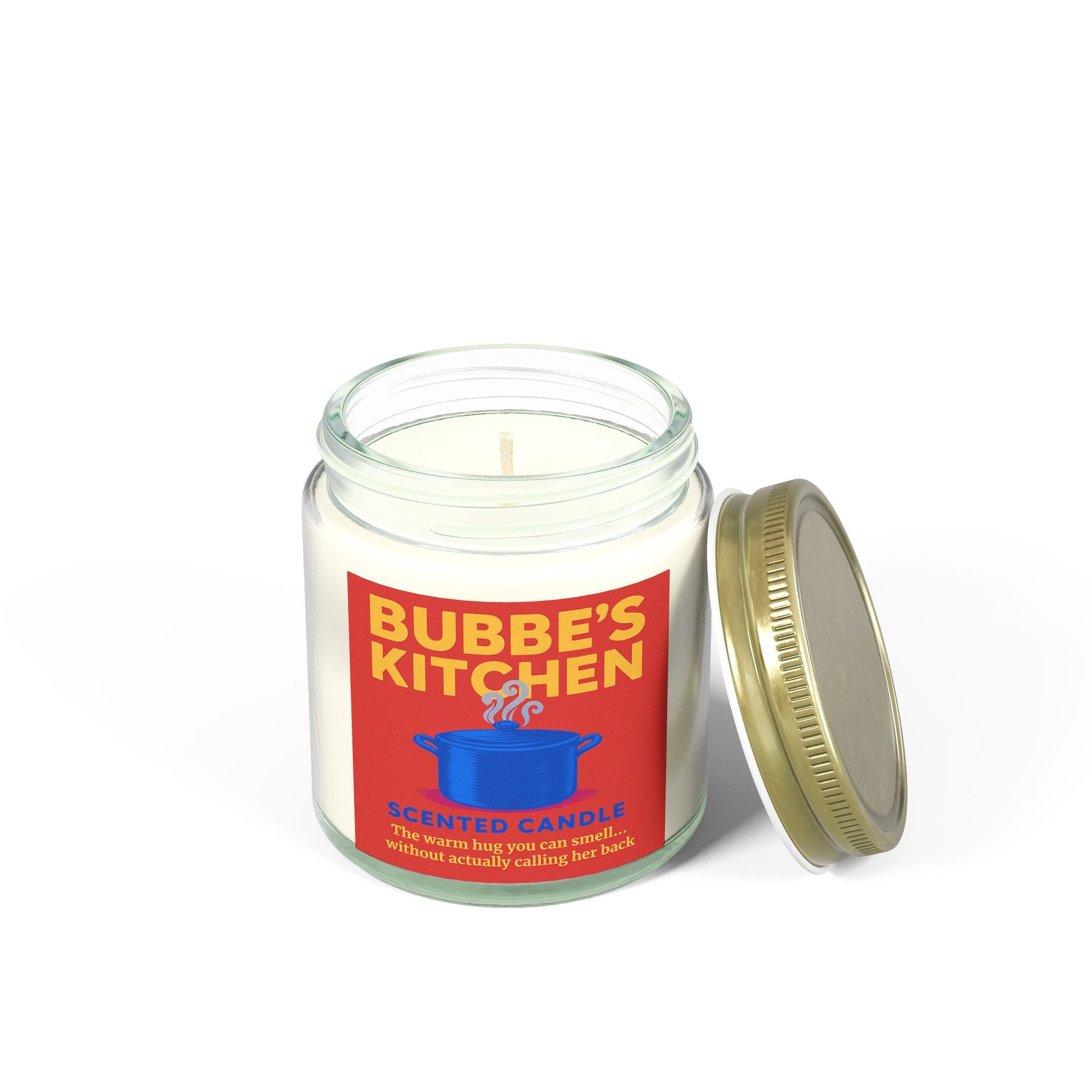 Candle in a glass jar with a red label featuring 'Bubbe's Kitchen' on a white background