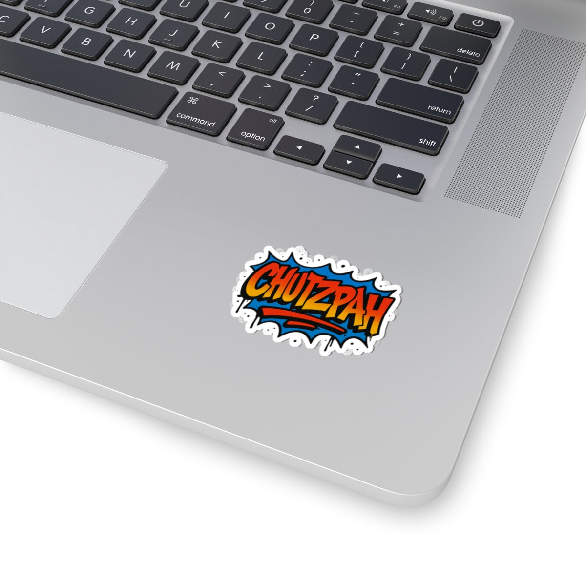 Laptop with a colorful 'CHUTZPAH' sticker on the palm rest area
