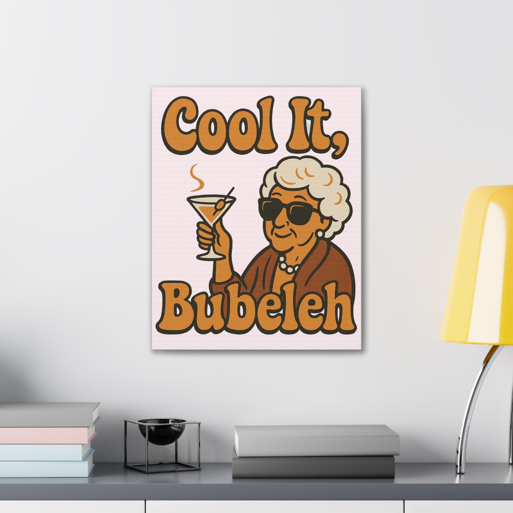 Canvas print with a cartoon character holding a cocktail and text 'Cool It, Bubeleh' on a wall.