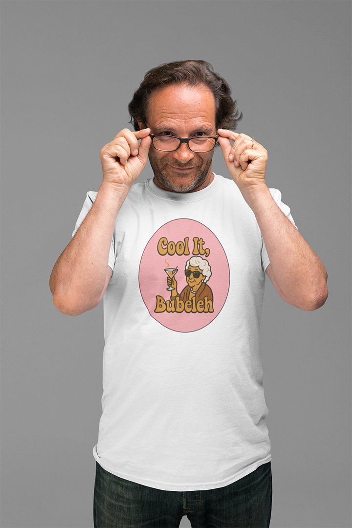 Man wearing a white t-shirt with a graphic design on a gray background