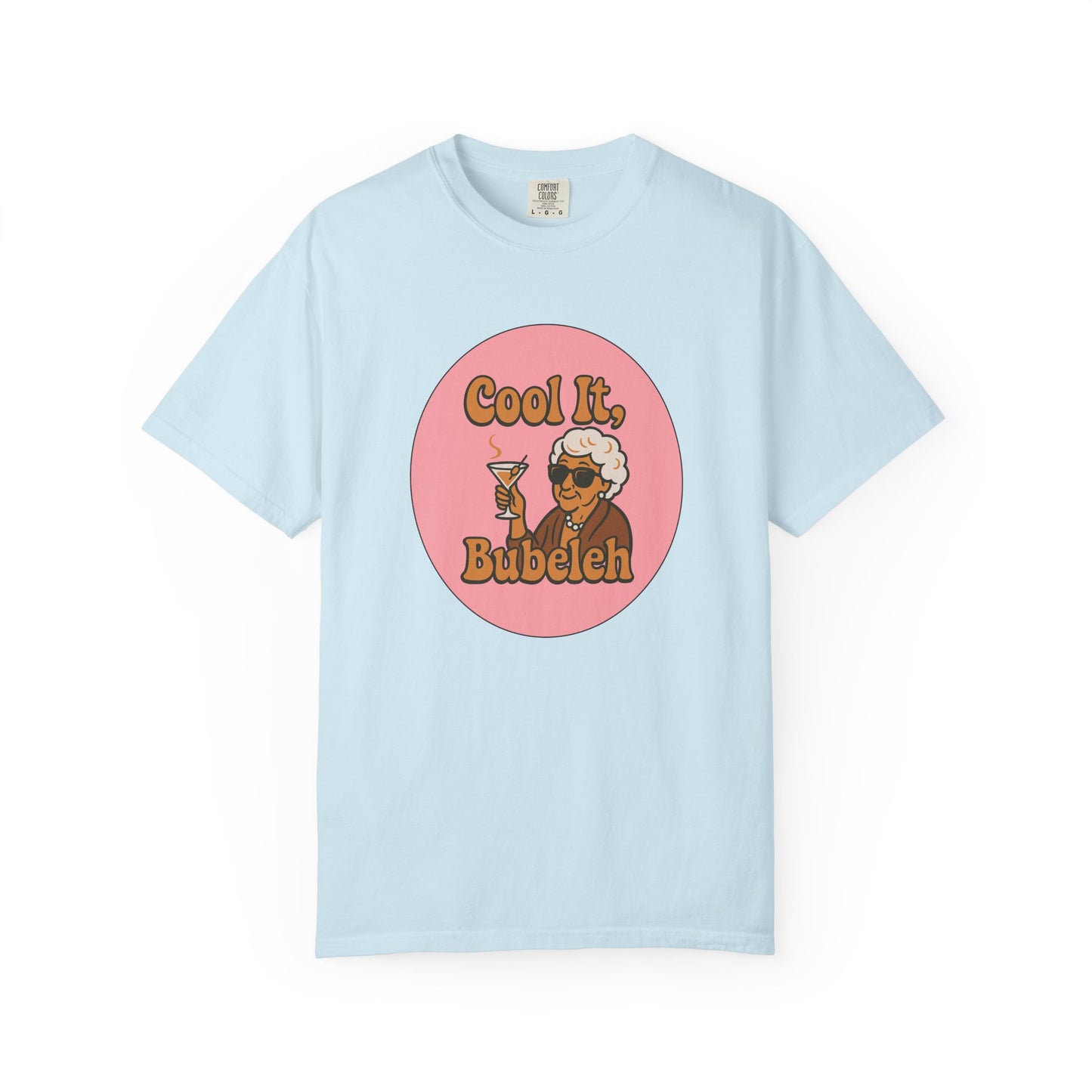 Light blue t-shirt with a graphic design of an elderly woman holding a drink and text 'Cool It, Bubeleh' on a white background.