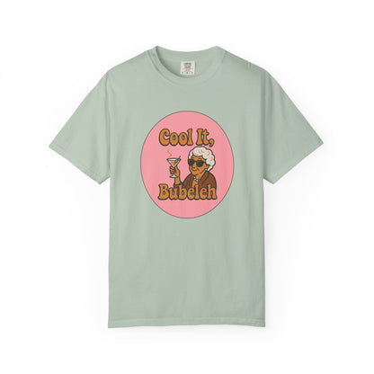 Mint green t-shirt with a graphic of a woman holding a drink and text 'Cool It, Bubeleh' on a white background