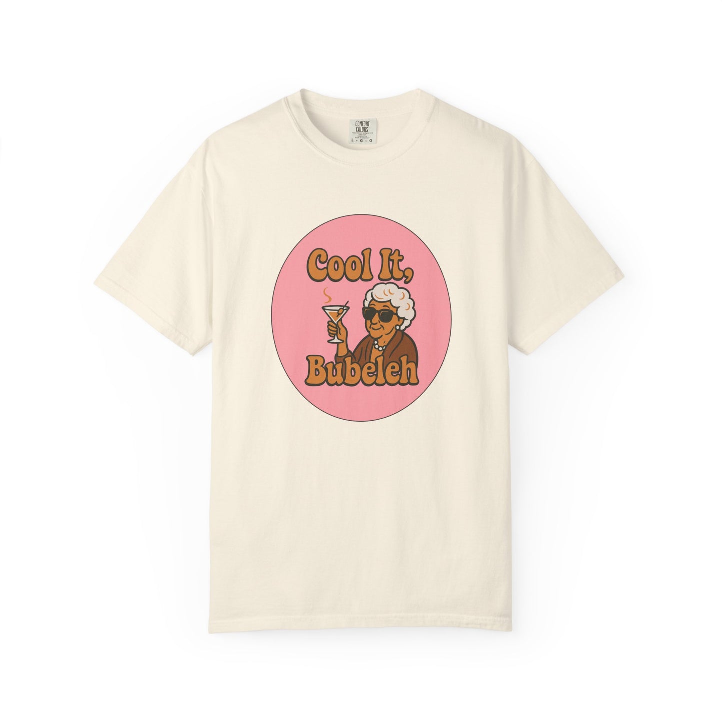 Beige t-shirt with a graphic of a woman holding a martini glass and text 'Cool It, Bubeleh' on a white background