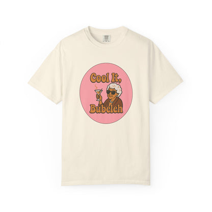 Beige t-shirt with a graphic of a woman holding a martini glass and text 'Cool It, Bubeleh' on a white background