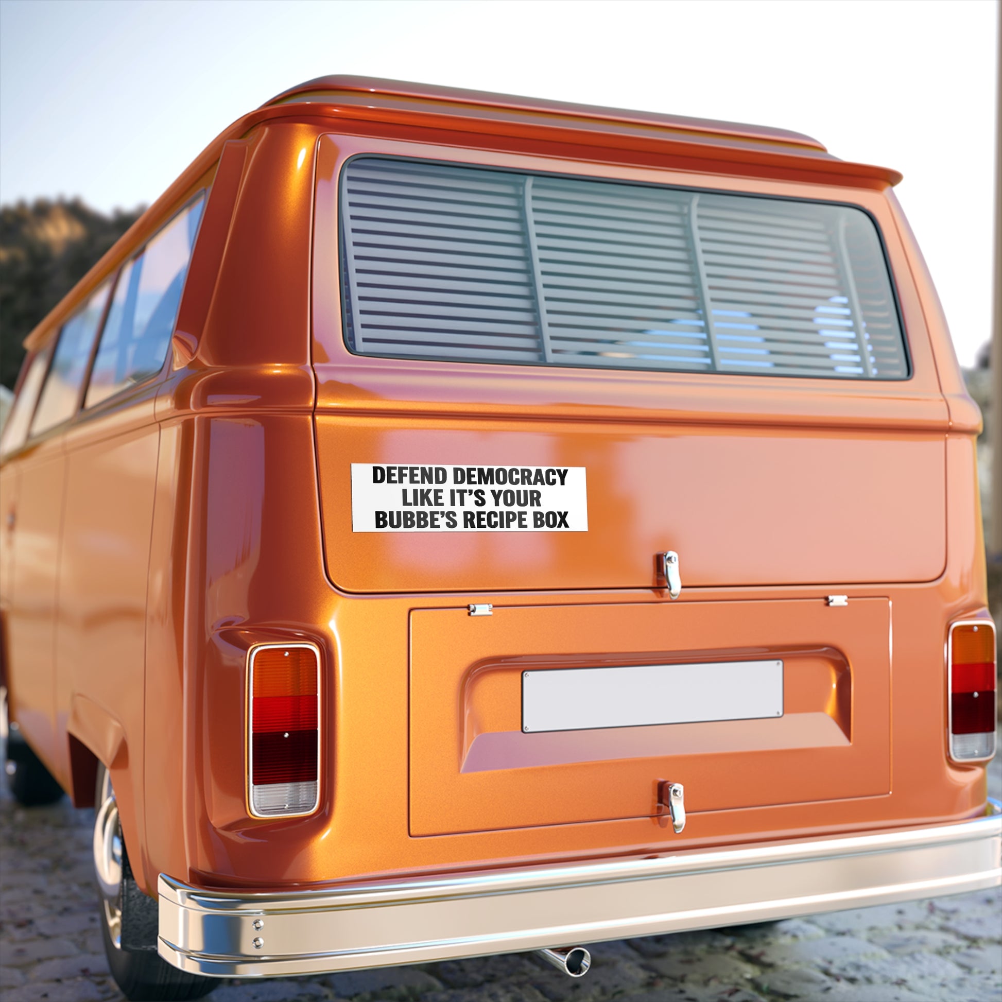 Orange van with a humorous sticker on the back