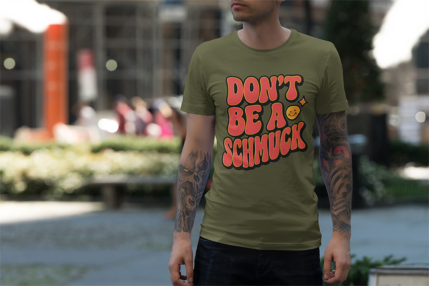 Person wearing a green t-shirt with red text in an urban setting