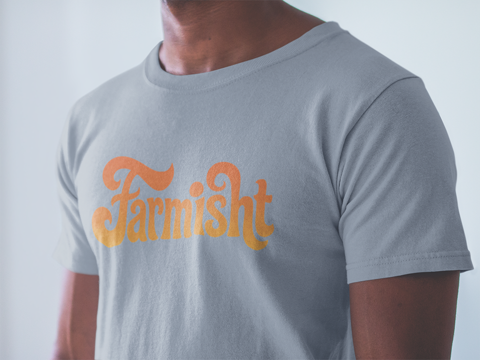 Gray t-shirt with orange 'Farmisht' logo worn by a person