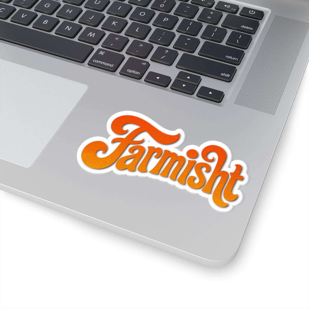 Laptop with a 'Farmisht' sticker on the palm rest area