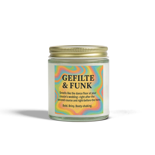 Candle jar with colorful label and gold lid on a white background