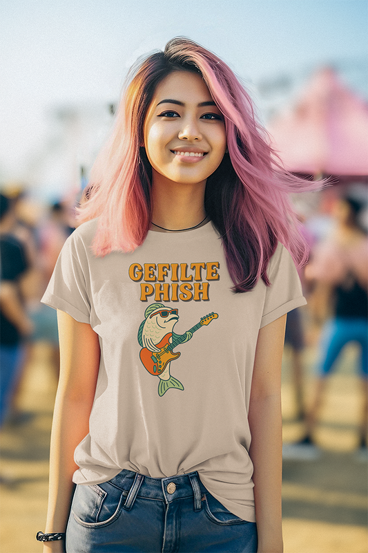Person wearing a t-shirt with 'Gefilte Phish' graphic design at an outdoor event.