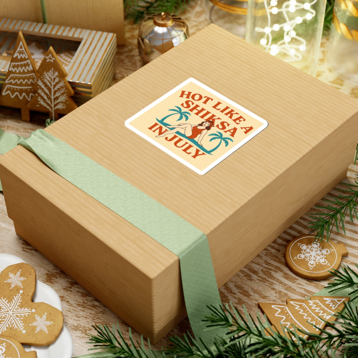 Wooden gift box with a decorative label on a festive background with cookies and Christmas decorations.