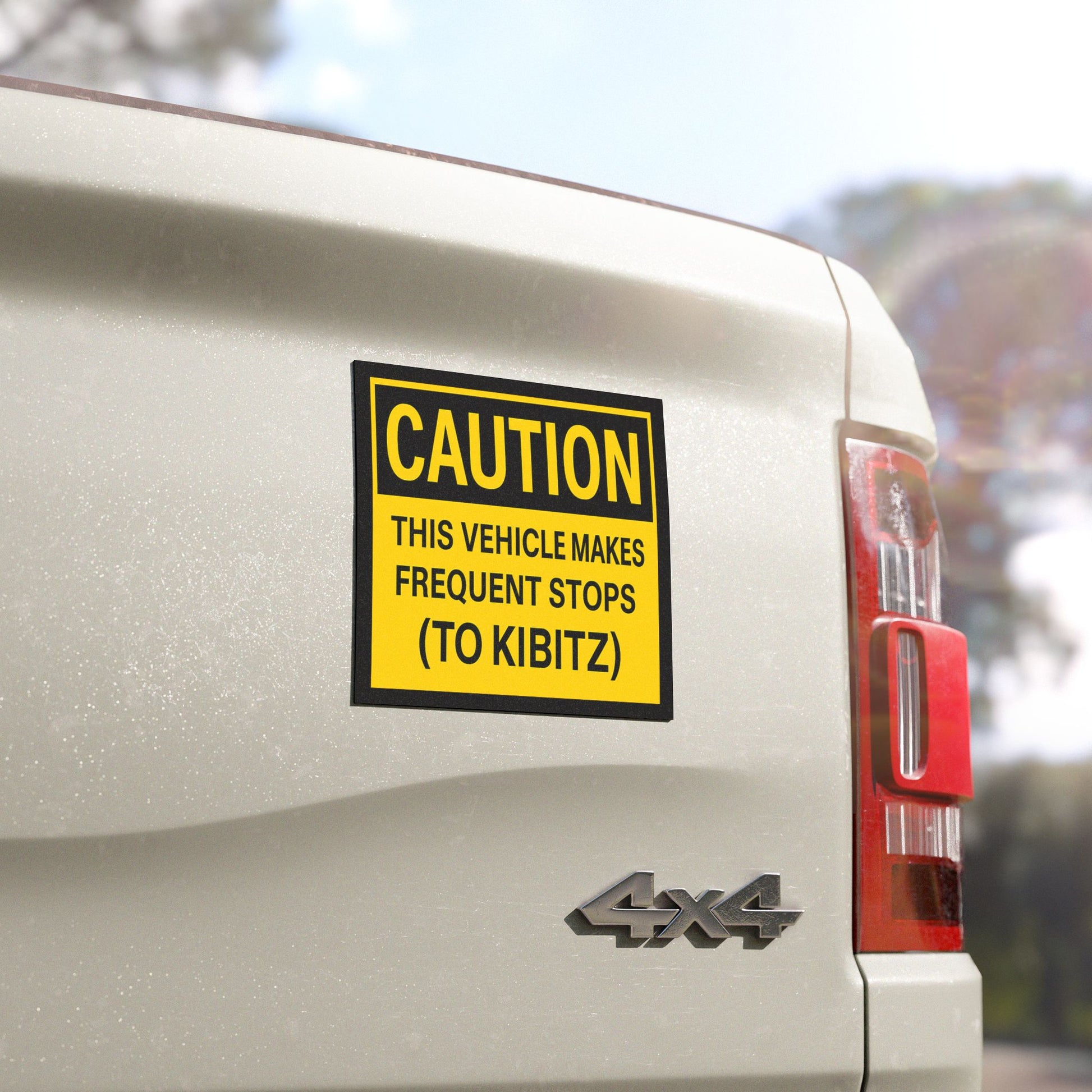 Caution magnet on a 4x4 vehicle's rear, with text 'This vehicle makes frequent stops (to kibitz).'
