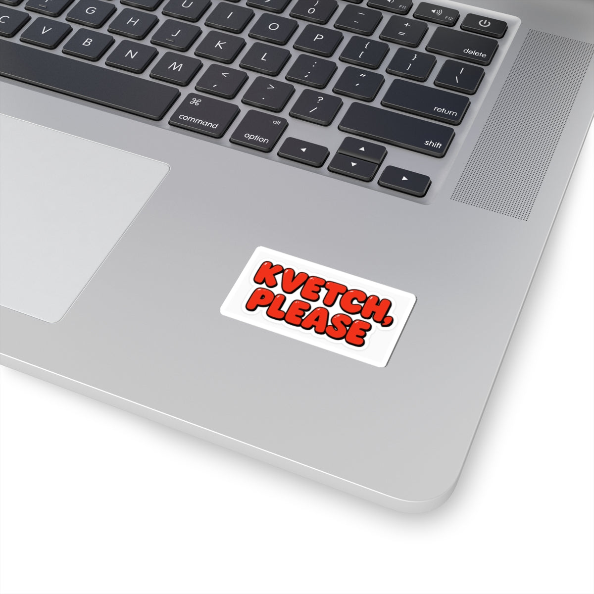 Laptop with a sticker that says 'KVETCH, PLEASE' on a white background